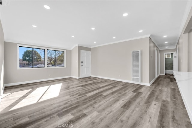 unfurnished living room featuring light hardwood / wood-style flooring and crown molding