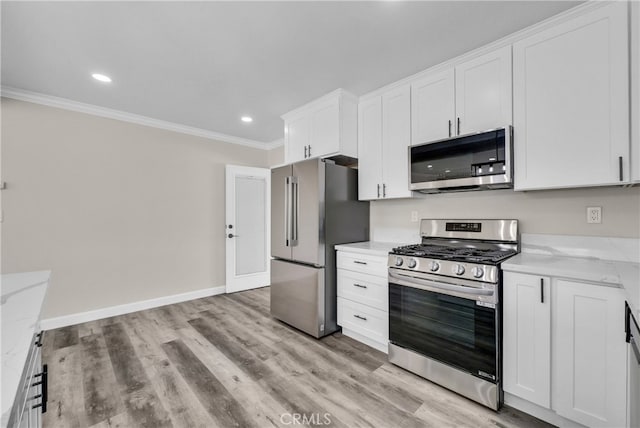 kitchen with appliances with stainless steel finishes, light wood-type flooring, light stone counters, crown molding, and white cabinetry