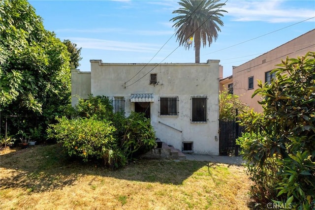 back of house with a lawn