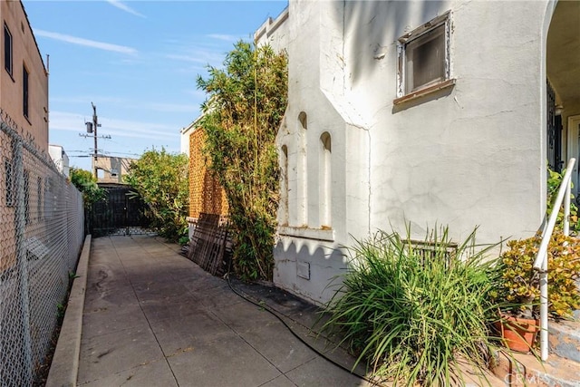 view of side of home with a patio