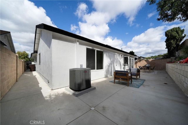 back of property with a patio and cooling unit