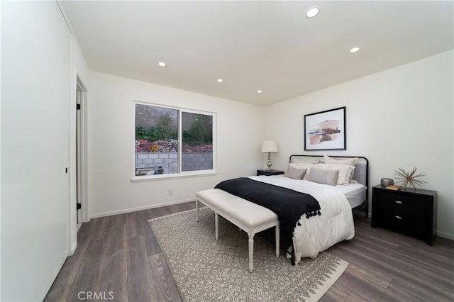 bedroom with dark hardwood / wood-style floors