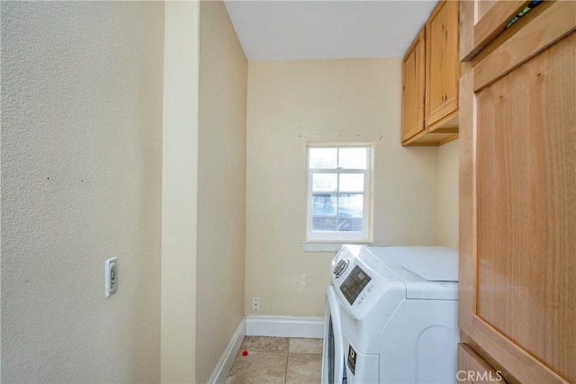 washroom featuring cabinets and independent washer and dryer