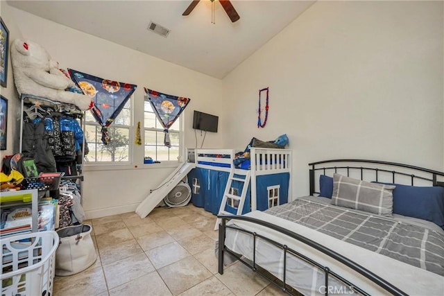 tiled bedroom featuring vaulted ceiling and ceiling fan