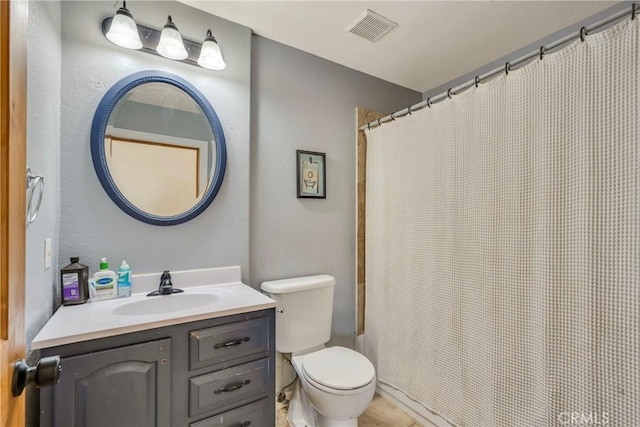 bathroom featuring vanity, toilet, and a shower with shower curtain