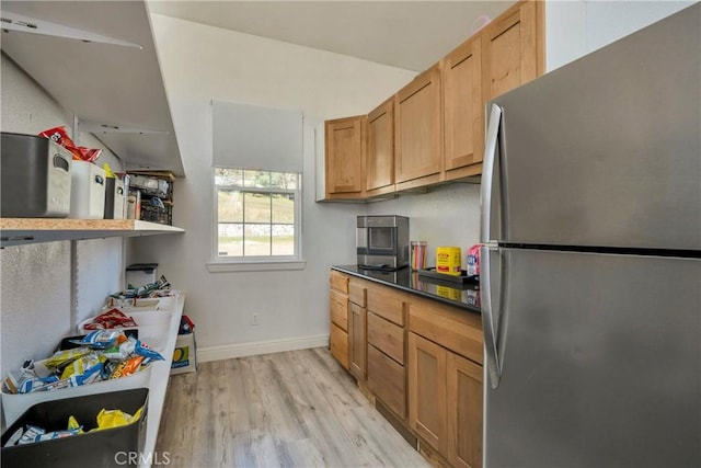 kitchen with stainless steel refrigerator and light hardwood / wood-style flooring