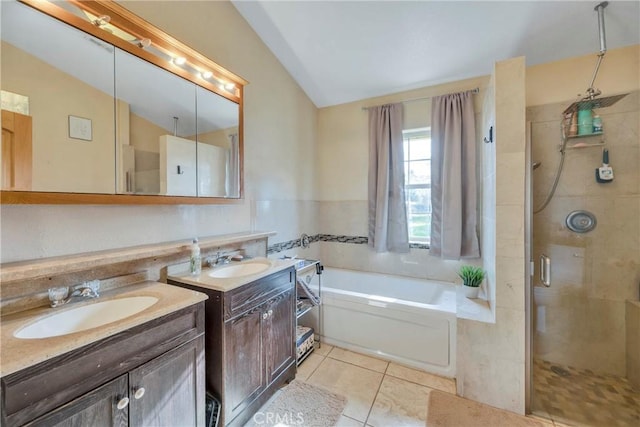 bathroom featuring vanity, vaulted ceiling, tile patterned floors, and independent shower and bath