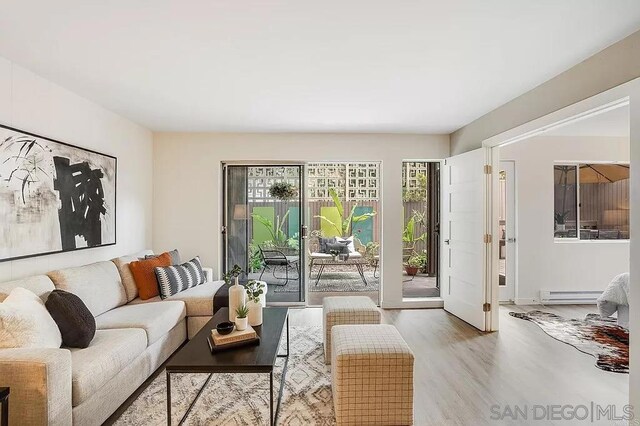 living room with hardwood / wood-style flooring and baseboard heating