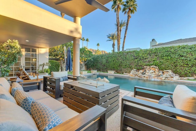 view of patio / terrace featuring an outdoor living space, a fenced in pool, and ceiling fan