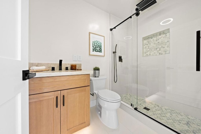 bathroom featuring an enclosed shower, vanity, toilet, and tile patterned floors