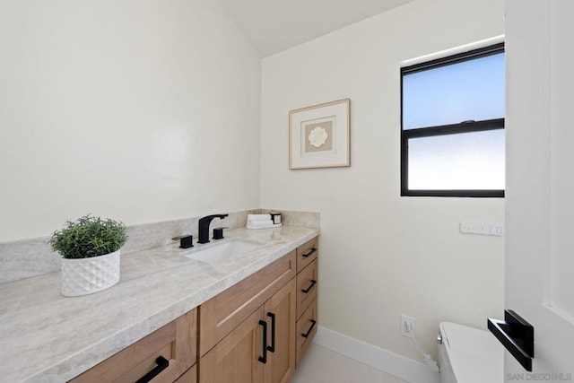 bathroom with tile patterned floors, vanity, toilet, and vaulted ceiling