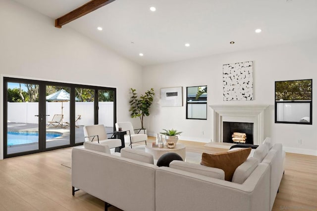 living room with french doors, beamed ceiling, high vaulted ceiling, and light wood-type flooring