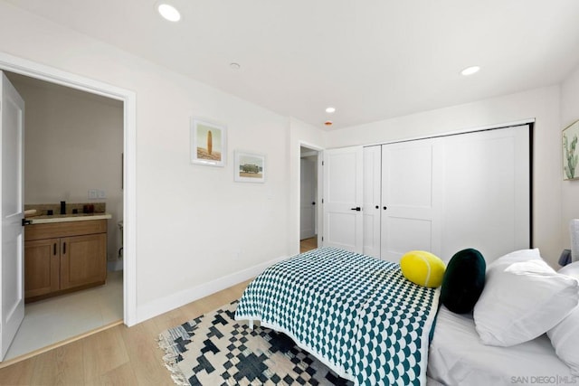 bedroom featuring light wood-type flooring and a closet