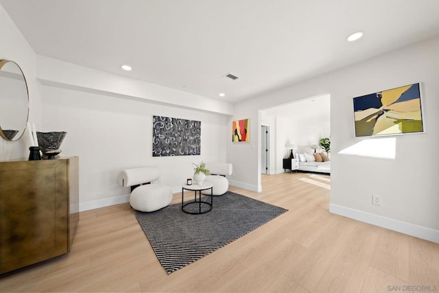 living area with hardwood / wood-style floors