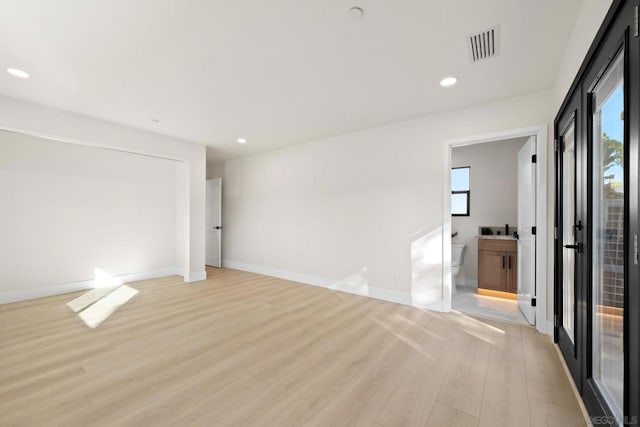 unfurnished room with light hardwood / wood-style flooring