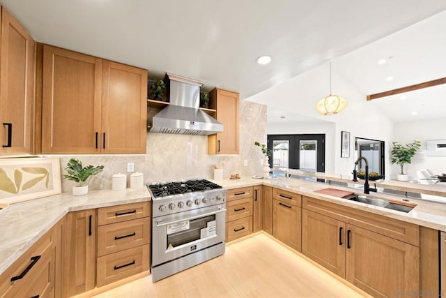 kitchen with lofted ceiling with beams, sink, wall chimney exhaust hood, light wood-type flooring, and high end stove