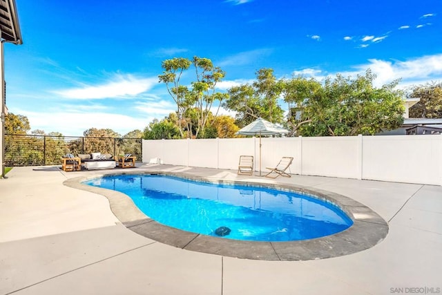 view of swimming pool with an outdoor living space and a patio area