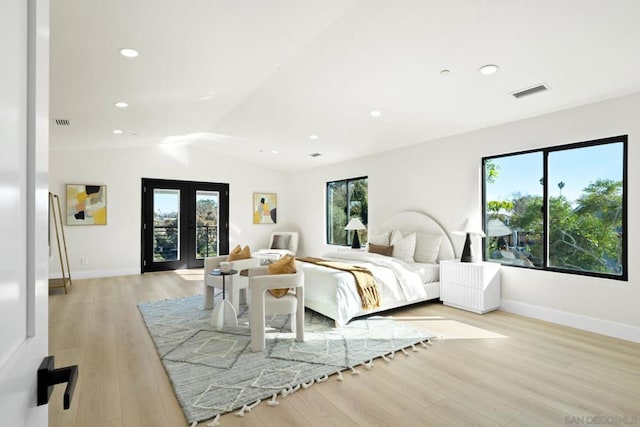 bedroom with light wood-type flooring, french doors, and vaulted ceiling