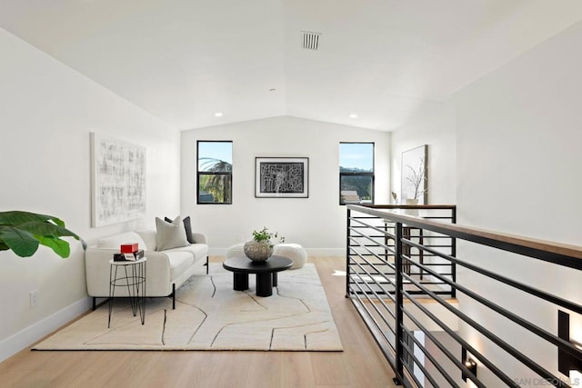 sitting room with light hardwood / wood-style flooring and vaulted ceiling