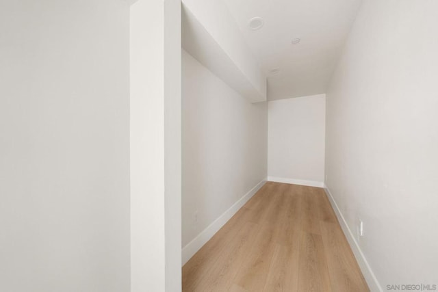 corridor with light hardwood / wood-style floors