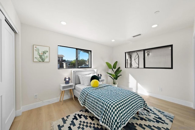 bedroom featuring a closet and light hardwood / wood-style flooring