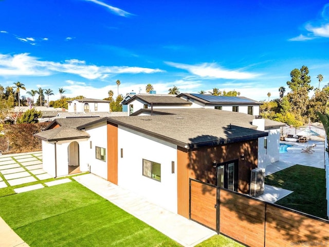 rear view of house featuring a yard