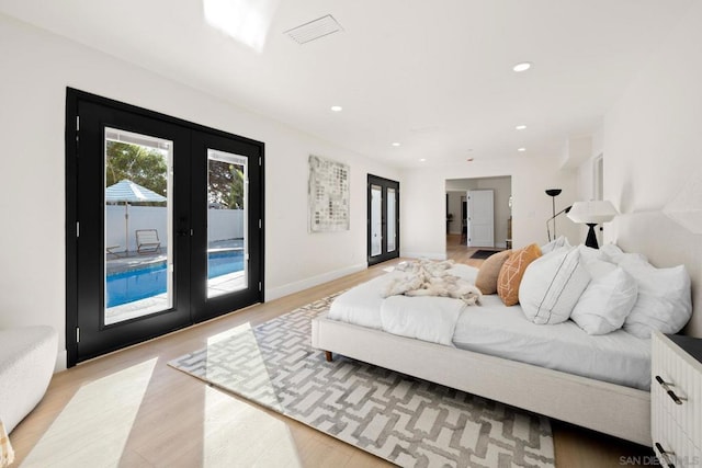 bedroom with light hardwood / wood-style flooring, access to outside, and french doors