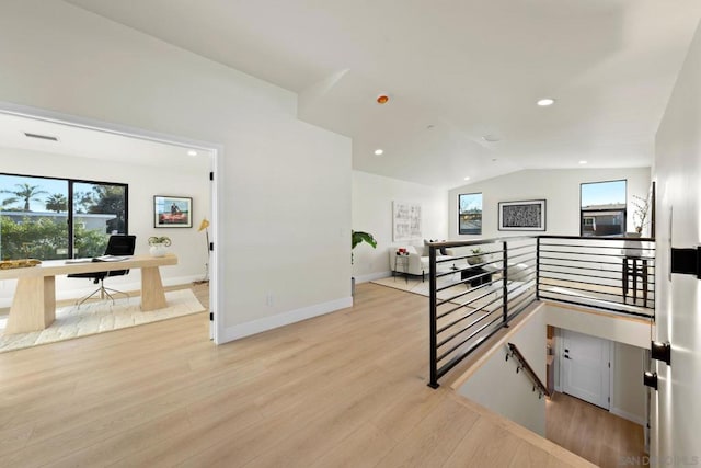 stairs featuring hardwood / wood-style flooring and vaulted ceiling