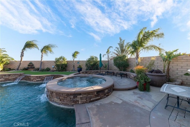 view of pool with an in ground hot tub and pool water feature