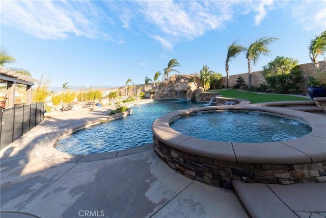 view of pool featuring pool water feature and an in ground hot tub