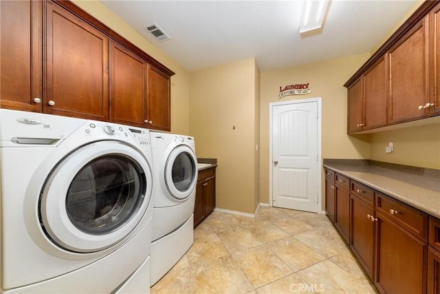 clothes washing area with light tile patterned floors, cabinets, and independent washer and dryer