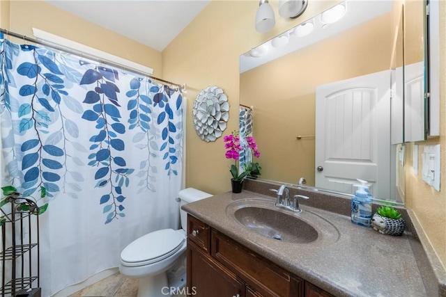 bathroom with tile patterned floors, vanity, and toilet