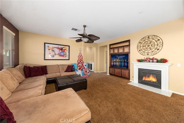 living room featuring ceiling fan and carpet floors