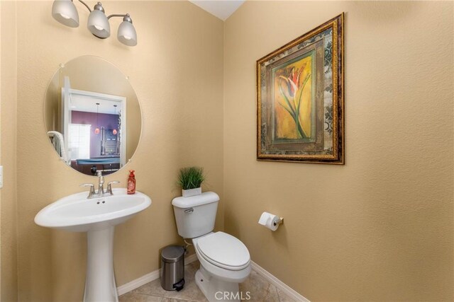 bathroom with tile patterned flooring and toilet