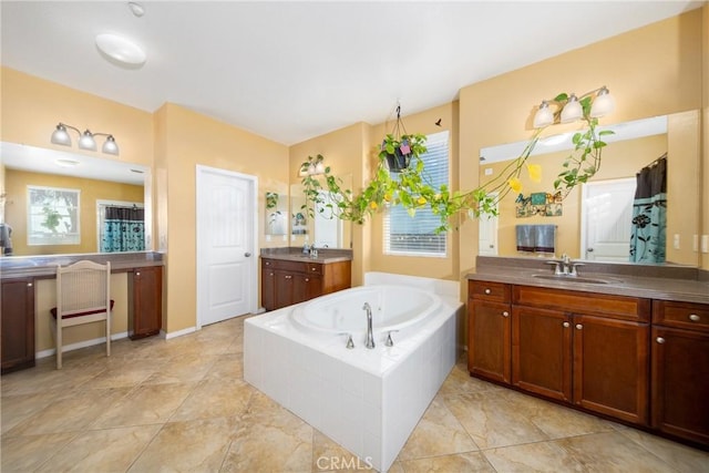 bathroom with vanity and a relaxing tiled tub