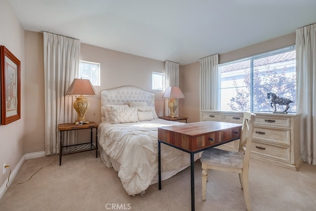 bedroom featuring light carpet