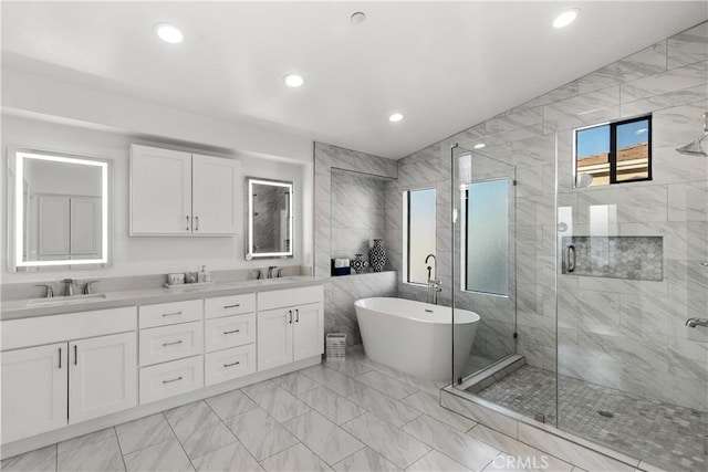 bathroom featuring vanity, tile walls, and separate shower and tub