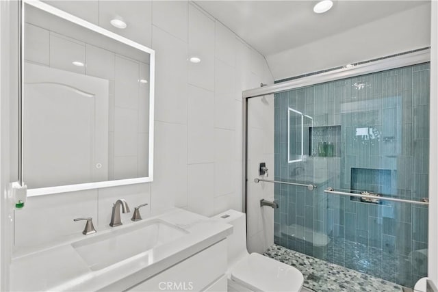 bathroom with vanity, an enclosed shower, and toilet