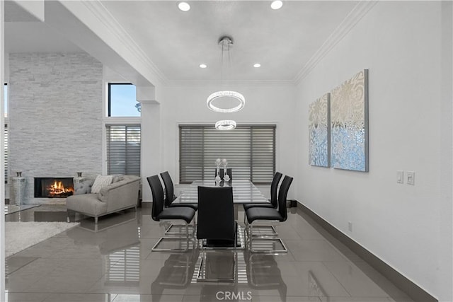 dining room featuring baseboards, recessed lighting, a fireplace, and crown molding