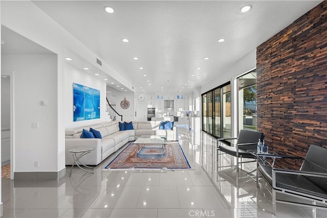 unfurnished living room featuring light tile patterned floors, baseboards, visible vents, and recessed lighting