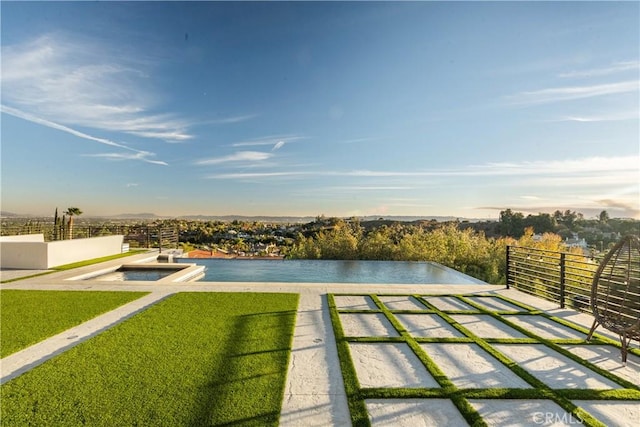 view of swimming pool featuring a water view and a yard