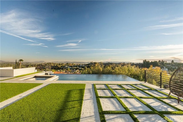 view of pool featuring a water view and a lawn