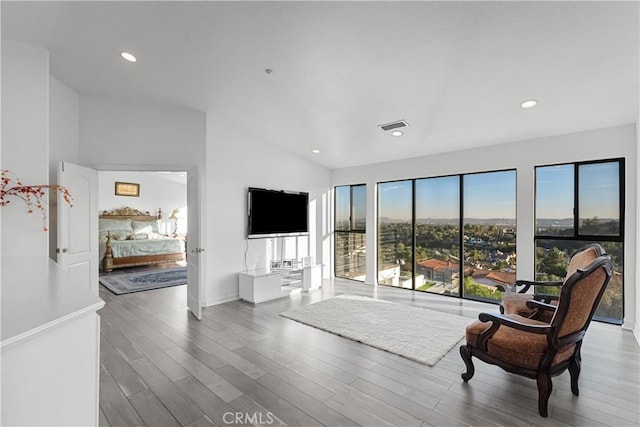 living room with lofted ceiling and hardwood / wood-style flooring