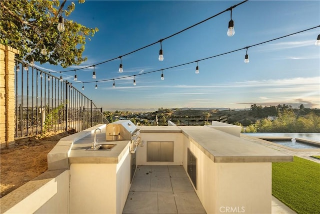 view of patio / terrace with area for grilling and sink