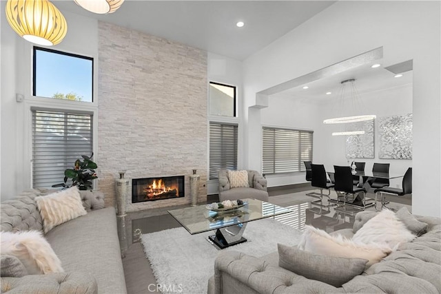 living room featuring a high ceiling and a fireplace