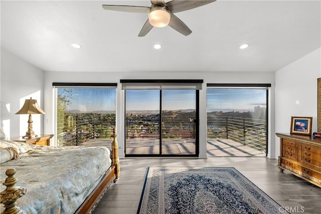 bedroom featuring multiple windows, access to outside, dark hardwood / wood-style floors, and ceiling fan