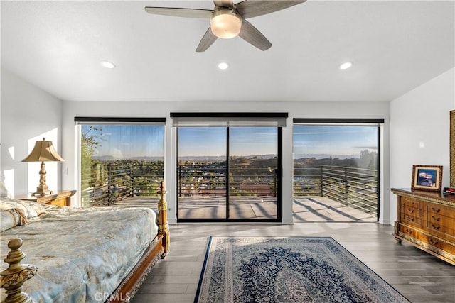 bedroom with dark wood-style floors, multiple windows, recessed lighting, and access to exterior