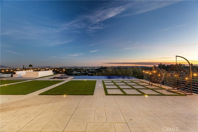 view of patio terrace at dusk