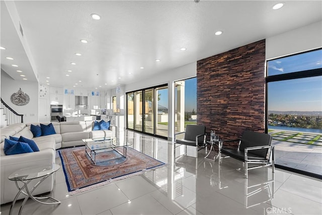 living room with stairway, light tile patterned flooring, and recessed lighting