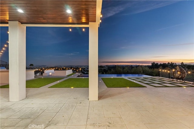 view of patio terrace at dusk